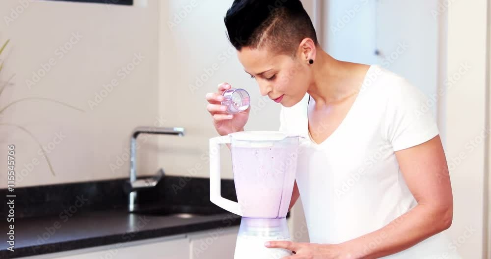 Pregnant woman mixing some fruits in the kitchen at home Pregnant woman mixing some fruits in the kitchen at home