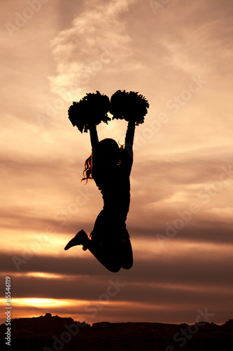cheerleader silhouette jumping in the air