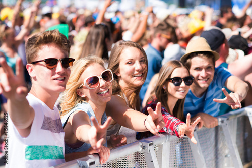 Teenagers at summer music festival having good time photo