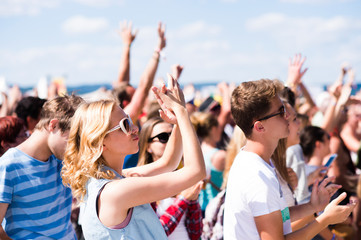 Teenagers at summer music festival having good time