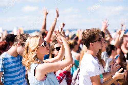 Teenagers at summer music festival having good time photo