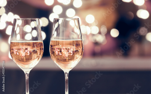 Wine glasses on a bar.

 photo