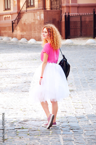 Young adult girl in purple keds and fluffy skirt
