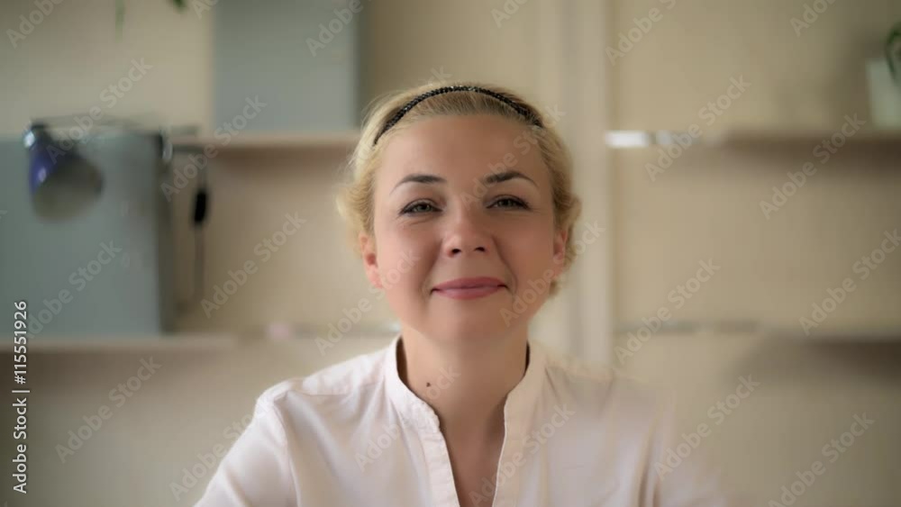 Happy middle aged business woman looking with smile at camera. She smiling and we can see her perfect teeth. Caucasian model kind and gentle. Happy middle aged business woman looking with smile at camera. She smiling and we can see her perfect teeth. Caucasian model kind and gentle.