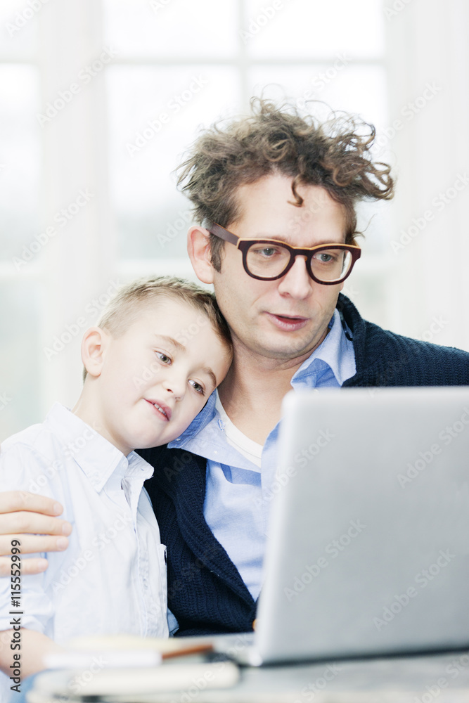 Father and son (6-7) using laptop Father and son (6-7) using laptop