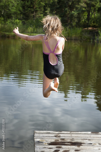 Sweden, Vastra Gotaland, Kallandso, Girl (12-13) jumping into water photo