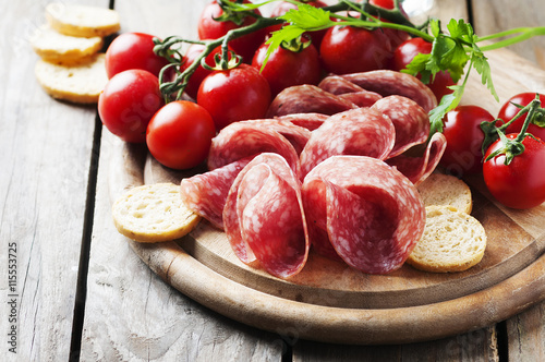 Fresh salami with tomato and bread