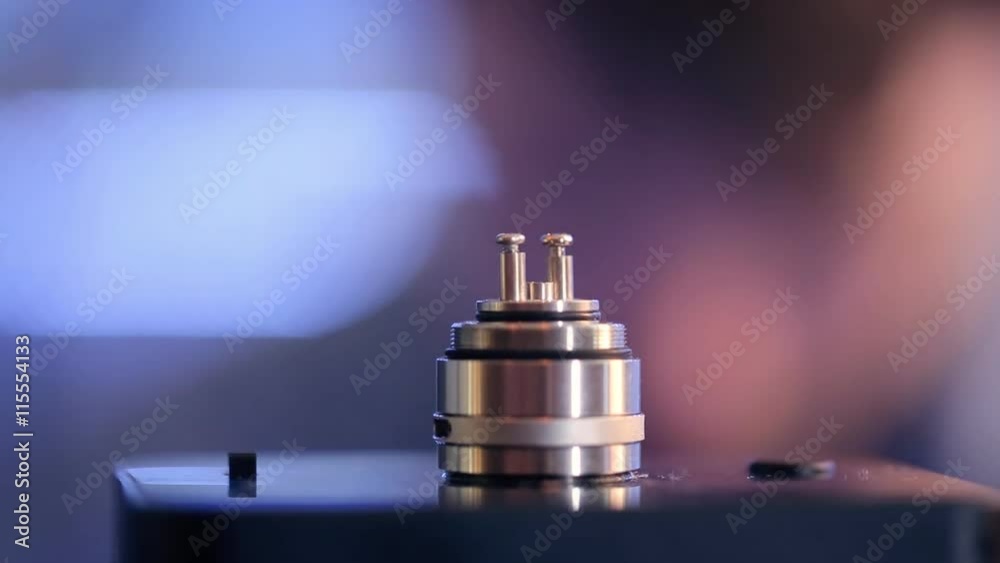 Accepted atomizer from electronic cigarette in a disassembled form closeup. Accepted atomizer from electronic cigarette in a disassembled form closeup.