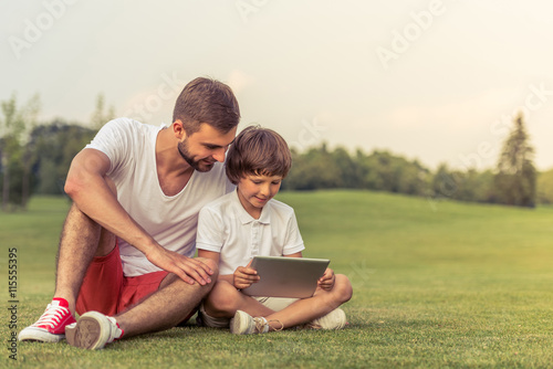 Dad and son with gadget