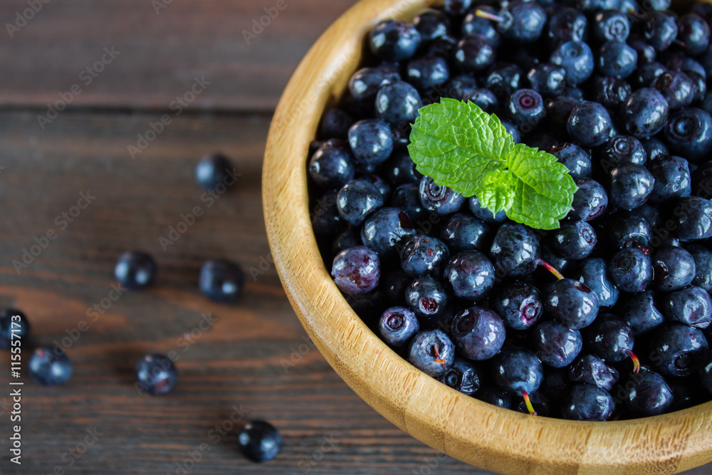blueberries in a bowl on wooden table blueberries in a bowl on wooden table