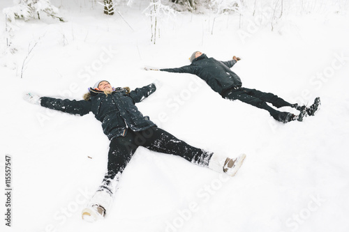 Finland, Jyvaskyla, Saakoski, Young couple making snow angel photo