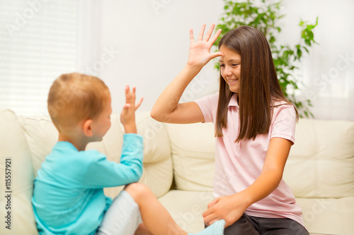 Brother and sister learn sign language at home