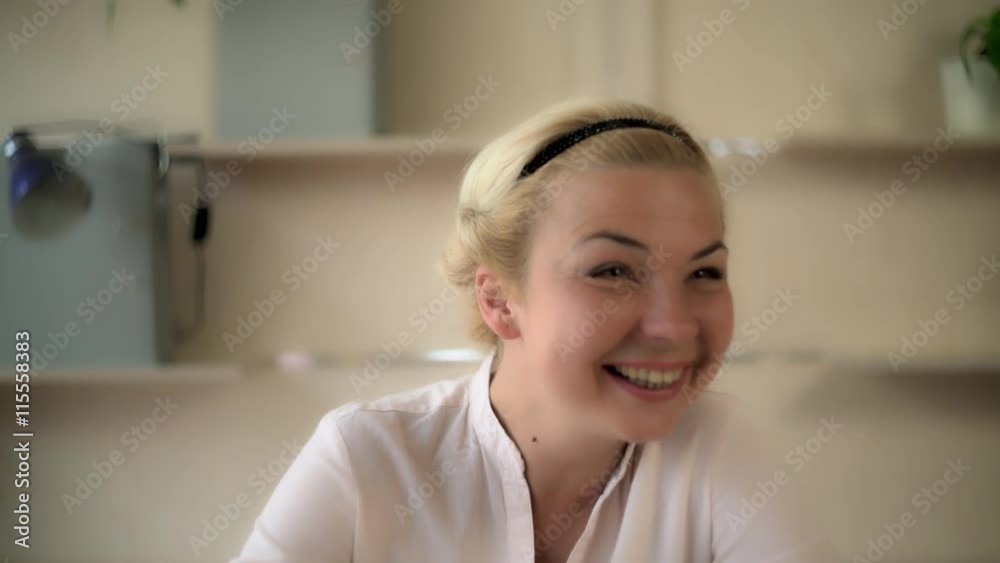 Portrait laughing middle aged woman. Female looking at the camera and laughs. She looks happy and glad. She received good news. Caucasian model with blonde hair. Portrait laughing middle aged woman. Female looking at the camera and laughs. She looks happy and glad. She received good news. Caucasian model with blonde hair.