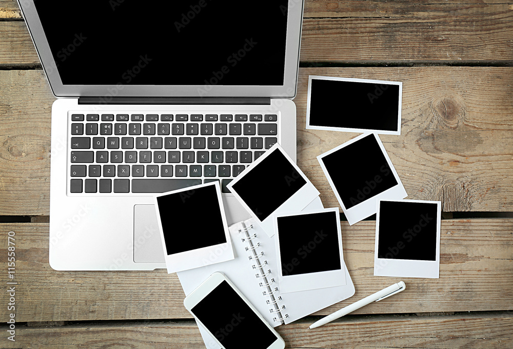 Laptop, notebook and photos on wooden background Laptop, notebook and photos on wooden background