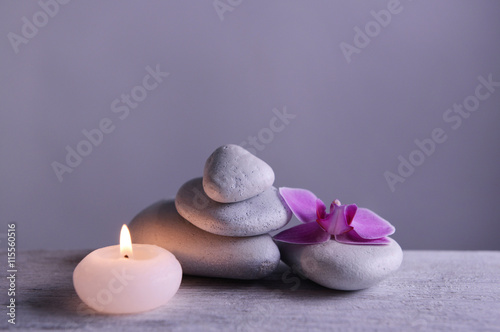Photography White spa stones with candle on gray background
