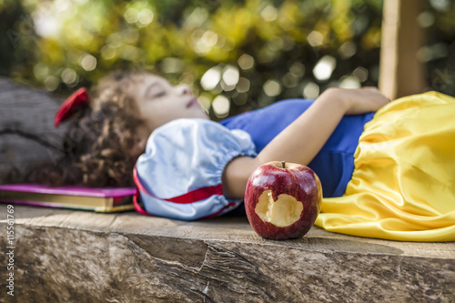 Young Snow White sleeping next to an apple