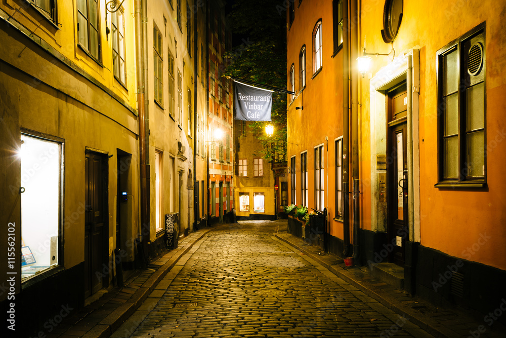 A narrow cobblestone street at night, in Galma Stan, Stockholm,