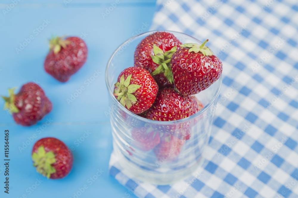 Glass of red strawberry with some berries Glass of red strawberry with some berries