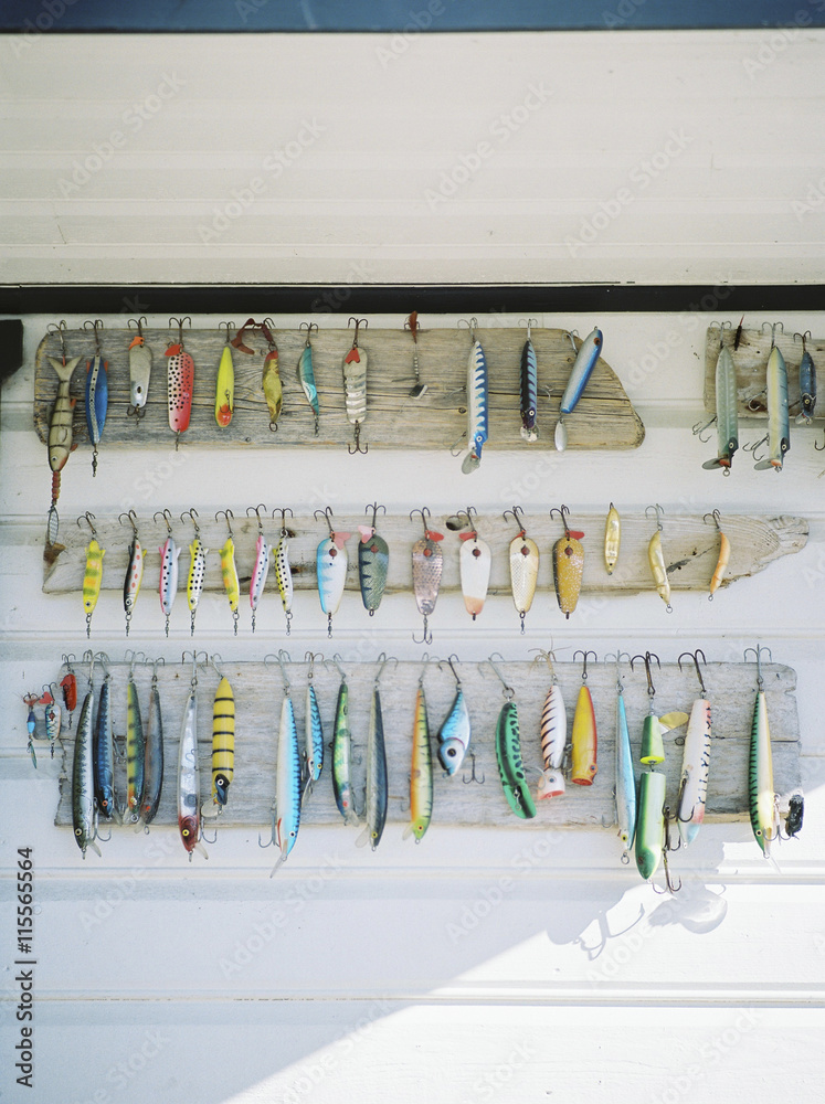 Variation of fishing tackle hanging on wall Stock Photo