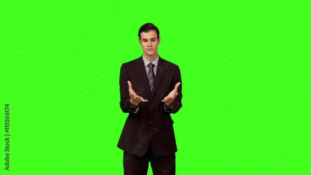 Businessman presenting with his hands on green screen background Businessman presenting with his hands on green screen background