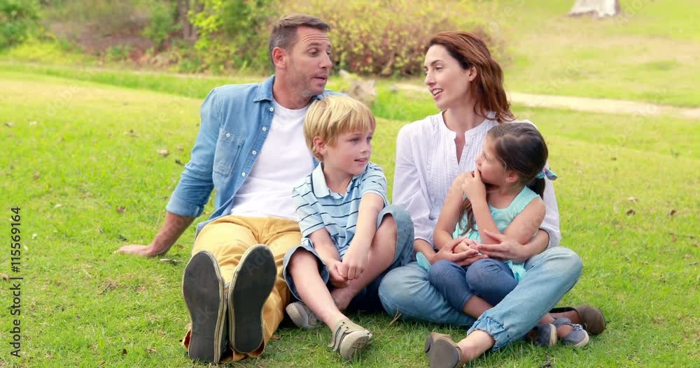 Happy family sitting on grass Happy family sitting on grass