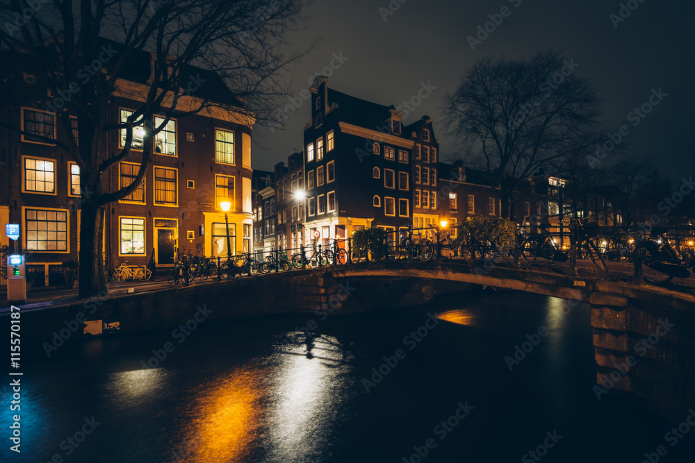 Bridge over a canal at night, in Amsterdam, Netherlands.