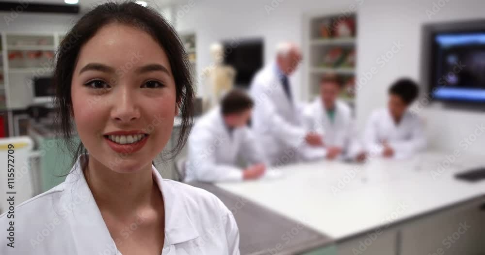Pretty medical student smiling at camera in class