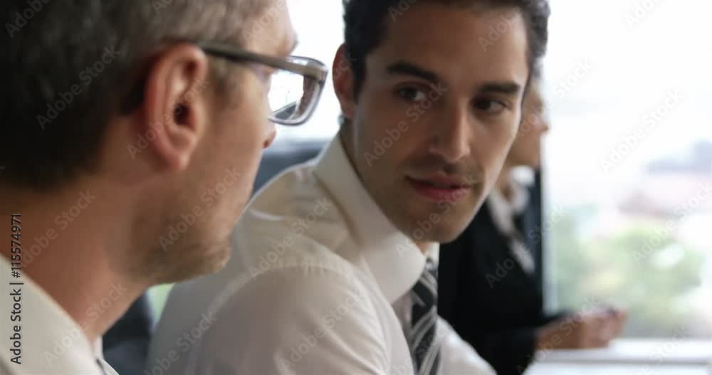 Businessmen talking together during a meeting Businessmen talking together during a meeting