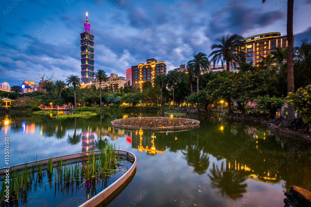 Taipei 101 and a lake at Zhongshan Park at night, in Xinyi, Taip