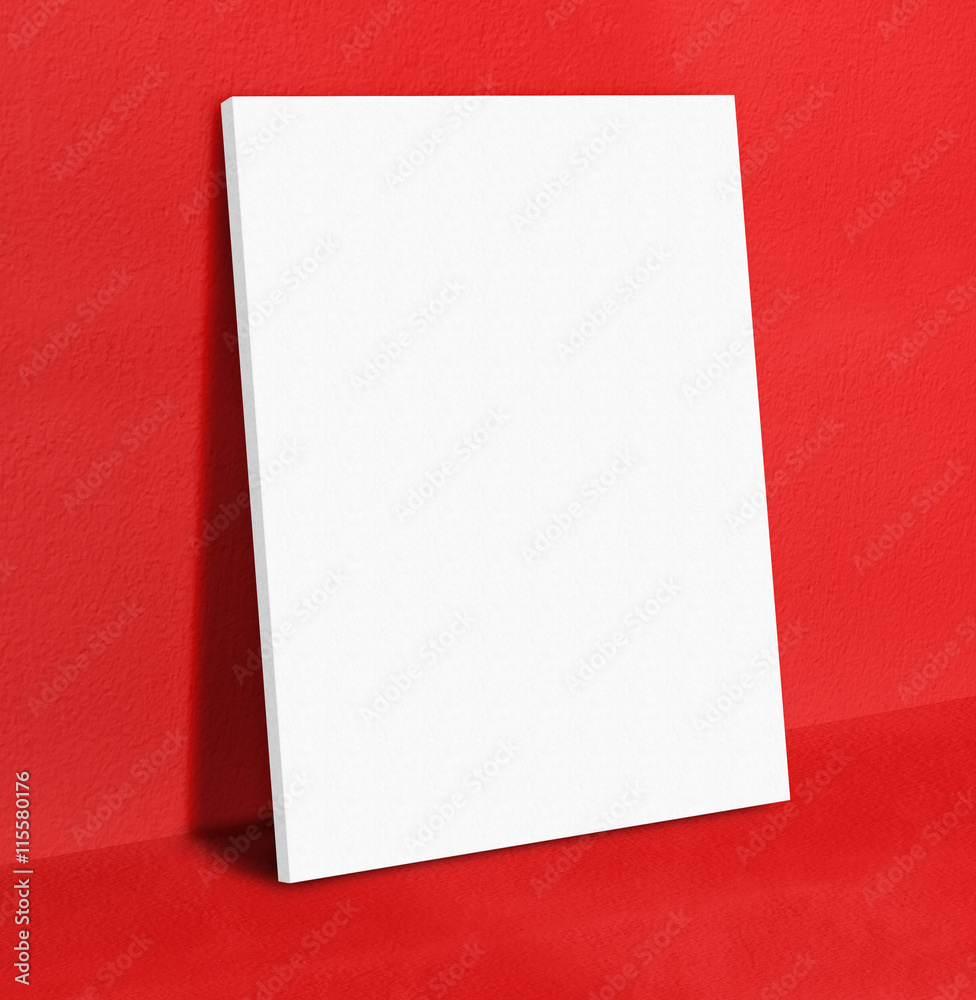 Blank white poster canvas frame leaning at red concrete paint wa Blank white poster canvas frame leaning at red concrete paint wa