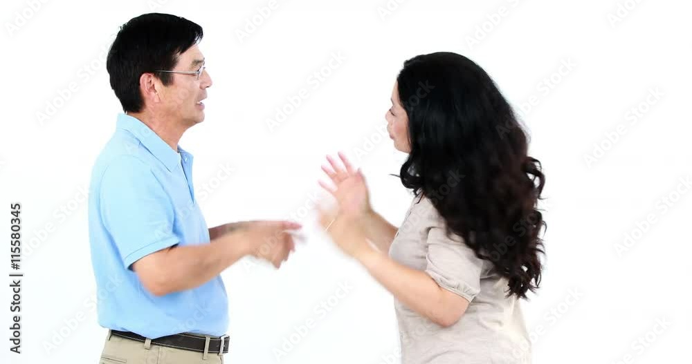 Couple not talking after arguing on white screen Couple not talking after arguing on white screen