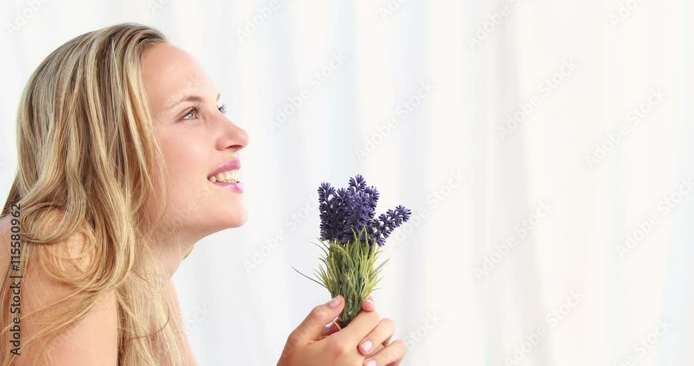 Pretty blonde woman smeling lavender in high quality 4k format