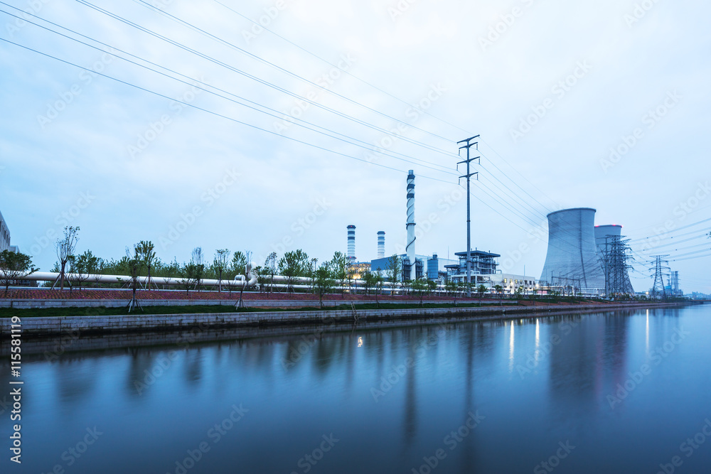 modern power station near water in twilight modern power station near water in twilight