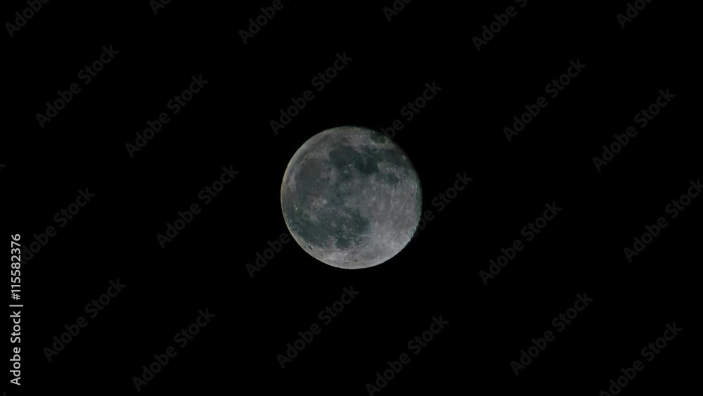 Full moon rise across frame time-lapse as it eventually becomes obscured by clouds Full moon rise across frame time-lapse as it eventually becomes obscured by clouds