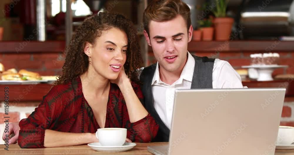 Happy hipster couple discussing and cuddling