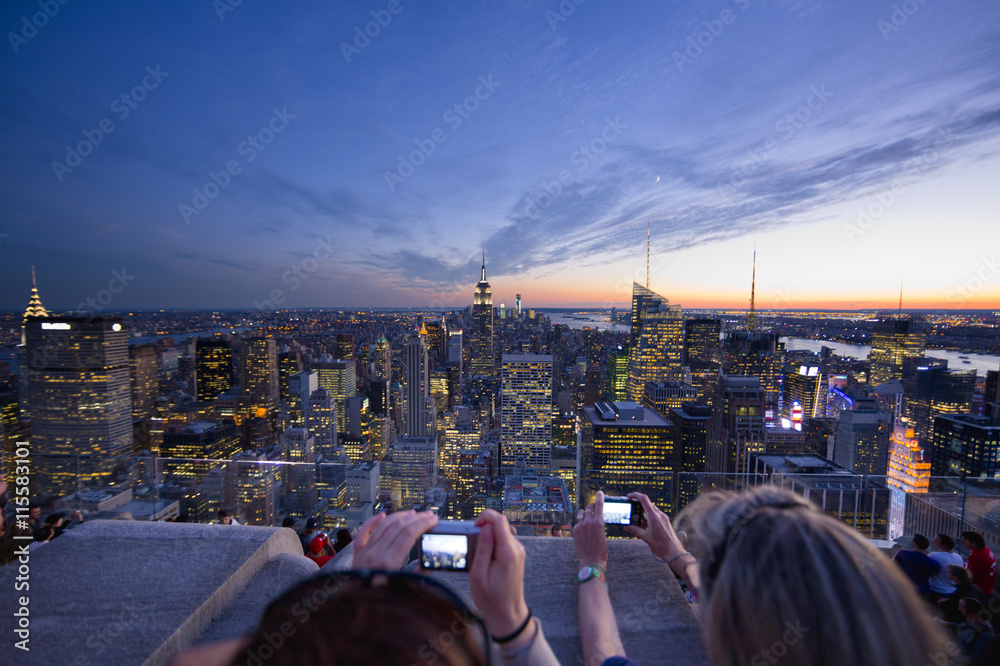 USA, New York State, New York City, Women photographing Manhattan at dusk