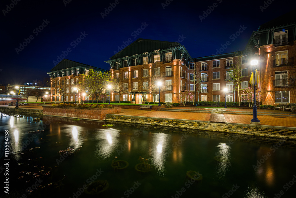 Apartment buildings along Carroll Creek at night, in Frederick,