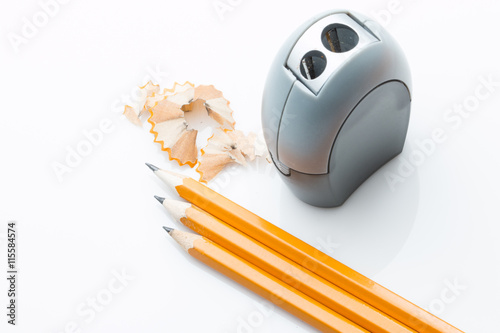 3 pencils and sharpner on white background photo
