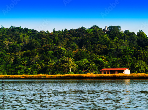 Horizontal vivid right aligned indian house on river landscape b photo