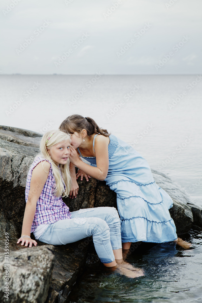 Sweden, Uppland, Roslagen, Two girls (12-13) playing at seaside Sweden, Uppland, Roslagen, Two girls (12-13) playing at seaside
