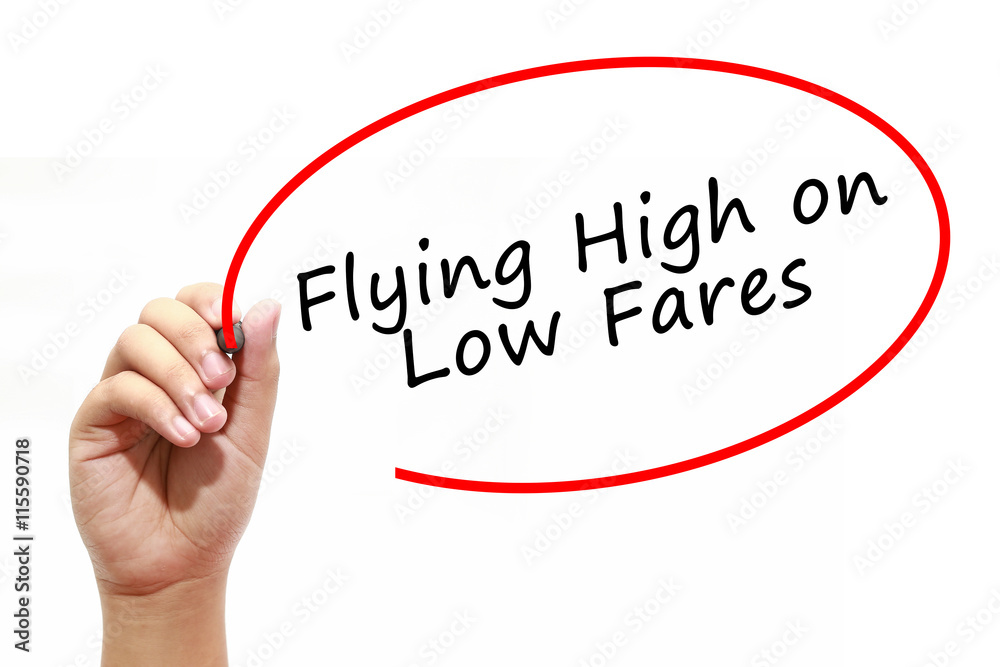 Man Hand writing Flying High on Low Fares with marker on transparent wipe board. Business, internet, technology concept. Man Hand writing Flying High on Low Fares with marker on transparent wipe board. Business, internet, technology concept.