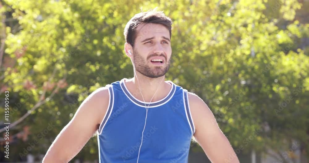 Happy jogger smiling at camera with thumbs up on the street Happy jogger smiling at camera with thumbs up on the street
