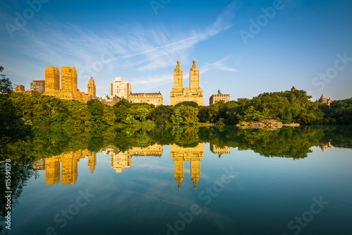 Buildings reflecting in The Lake, at Central Park, in Manhattan,