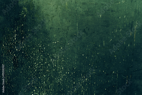 Old green colored Grunge background / Dark textured wall closeup