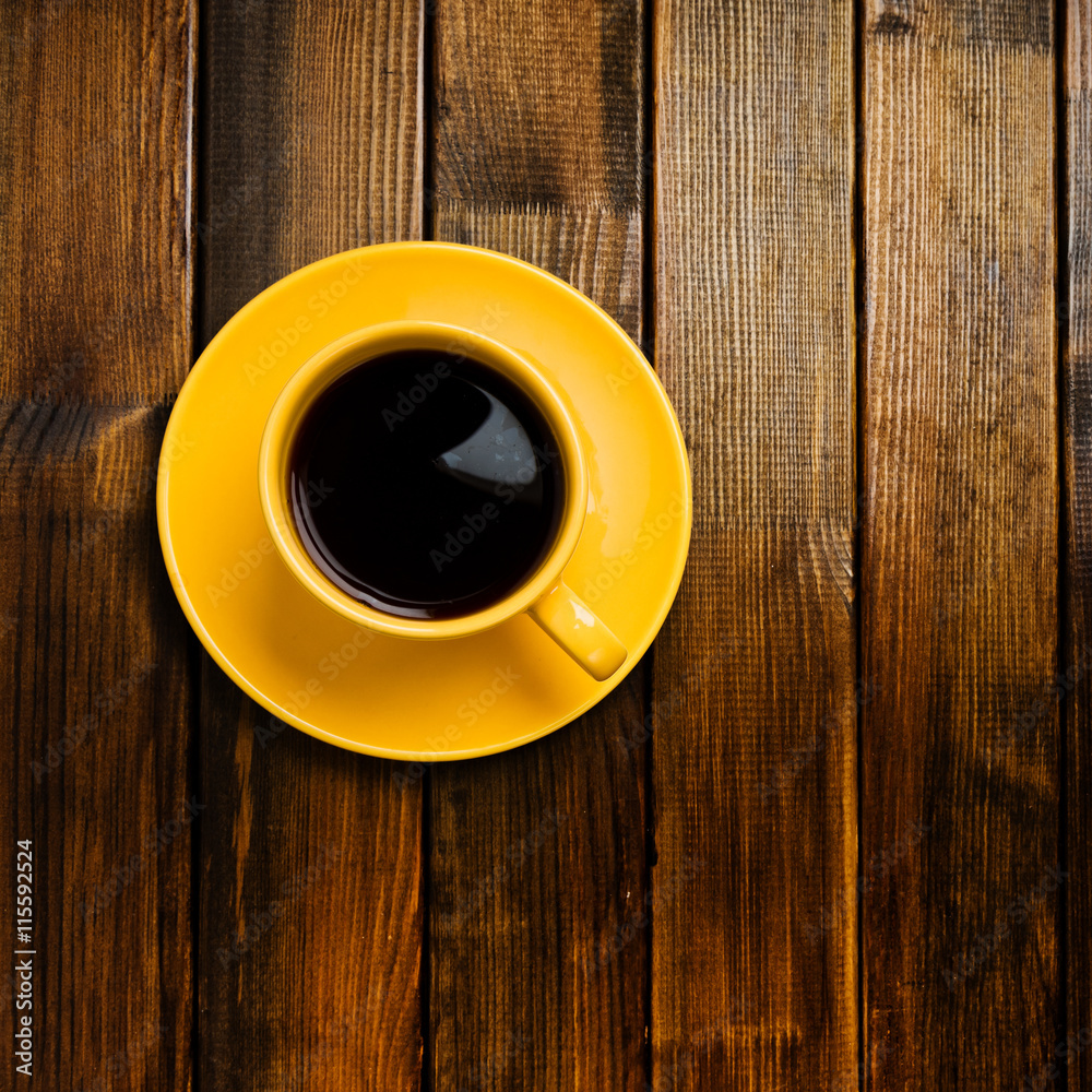 yellow cup coffee on wood background yellow cup coffee on wood background