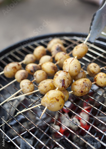 Sweden, Stockholm, Close up of potatoes on barbecue grill