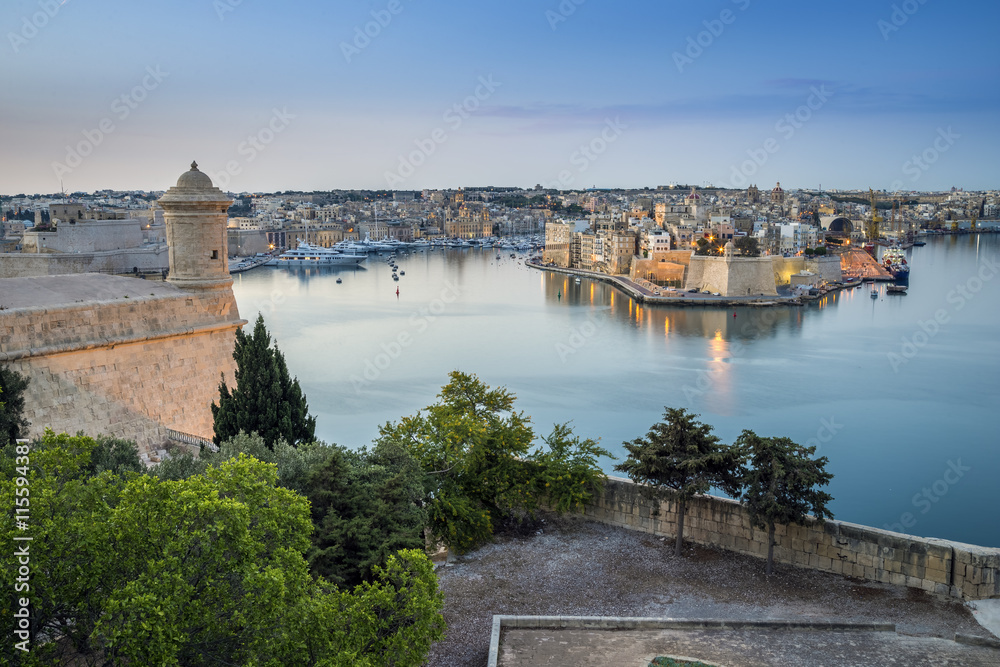 Valletta, Malta - Early morning skyline view of the Grand Harbour of Malta with watch tower and Senglea at the background
