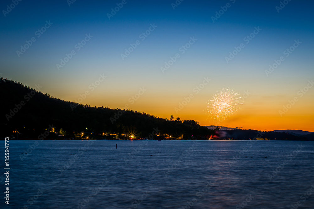 Fireworks and Lake Winnipesaukee at sunset, at Ellacoya State Pa
