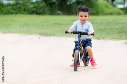 Fototapeta Naklejka Na Ścianę i Meble -  Little boy cycling at outdoor