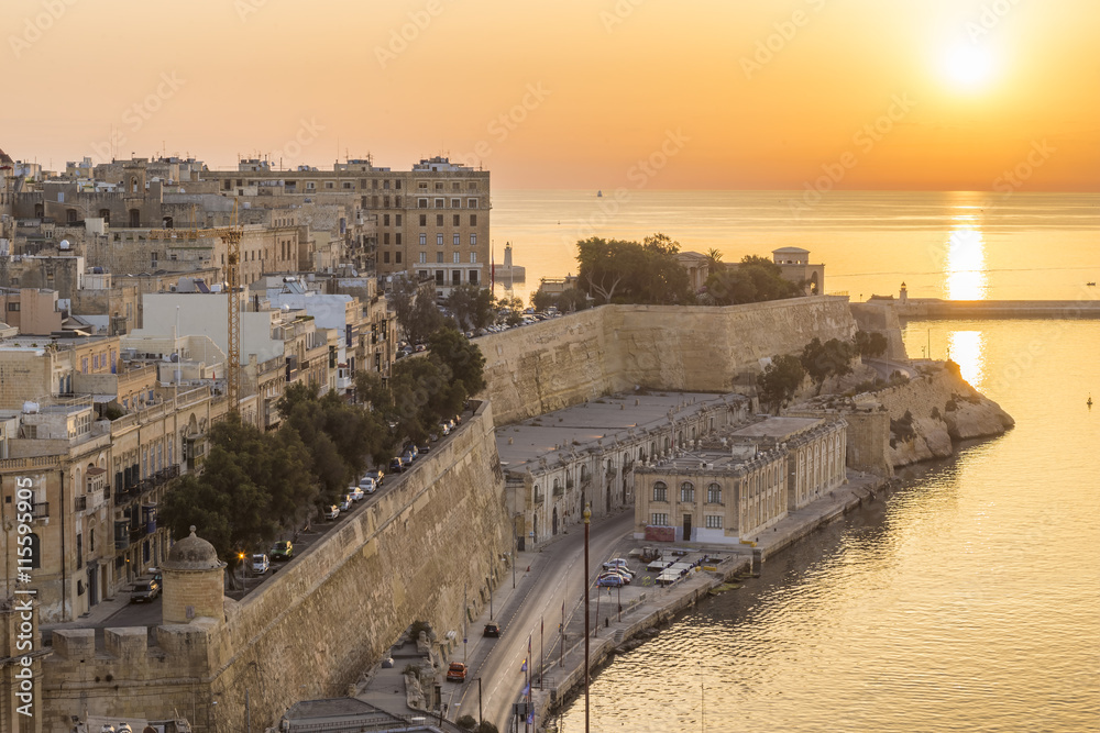 Sunrise in Malta with the ancient wall of Valletta and Grand Harbour